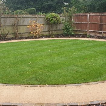 Large circle of artificial grass in garden