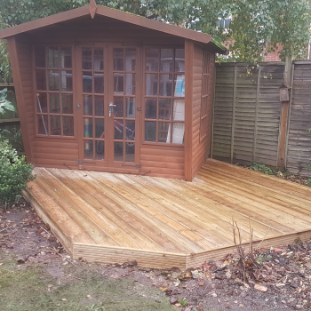 Decking in garden with shed on top